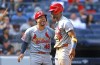 St. Louis Cardinals' Iván Herrera (48) and Jordan Walker (18) celebrate after scoring against the New York Yankees during the seventh inning of a baseball game, Sunday, Sept. 1, 2024, in New York. (AP Photo/Noah K. Murray)
