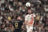 Roma's Bryan Cristante jumps for the ball with Juventus' Dusan Vlahovic during the Serie A soccer match between Juventus and Roma at the Allianz Stadium in Turin, Italy, Sunday, Sept. 1, 2024. (Marco Alpozzi/LaPresse via AP)