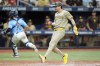 San Diego Padres' Tyler Wade scores on a sacrifice fly by Xander Bogaerts as Tampa Bay Rays catcher Ben Rortvedt (30) chases a wild throw during the ninth inning of a baseball game Sunday, Sept. 1, 2024, in St. Petersburg, Fla. (AP Photo/Chris O'Meara)
