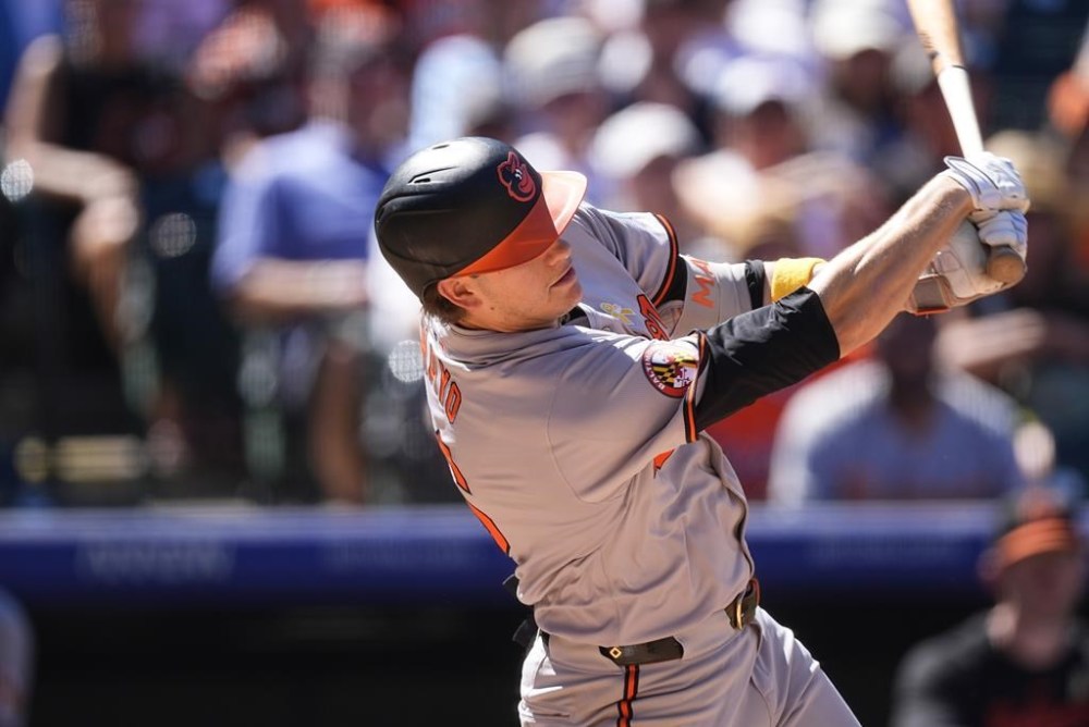 Baltimore Orioles' Coby Mayo swings at a pitch from Colorado Rockies reliever Jake Bird in the sixth inning of a baseball game Sunday, Sept. 1, 2024, in Denver. (AP Photo/David Zalubowski)