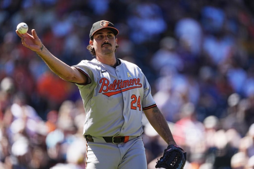 Baltimore Orioles starting pitcher Zach Eflin throws to first base to put out Colorado Rockies' Ezequiel Tovar and end the sixth inning of a baseball game Sunday, Sept. 1, 2024, in Denver. (AP Photo/David Zalubowski)