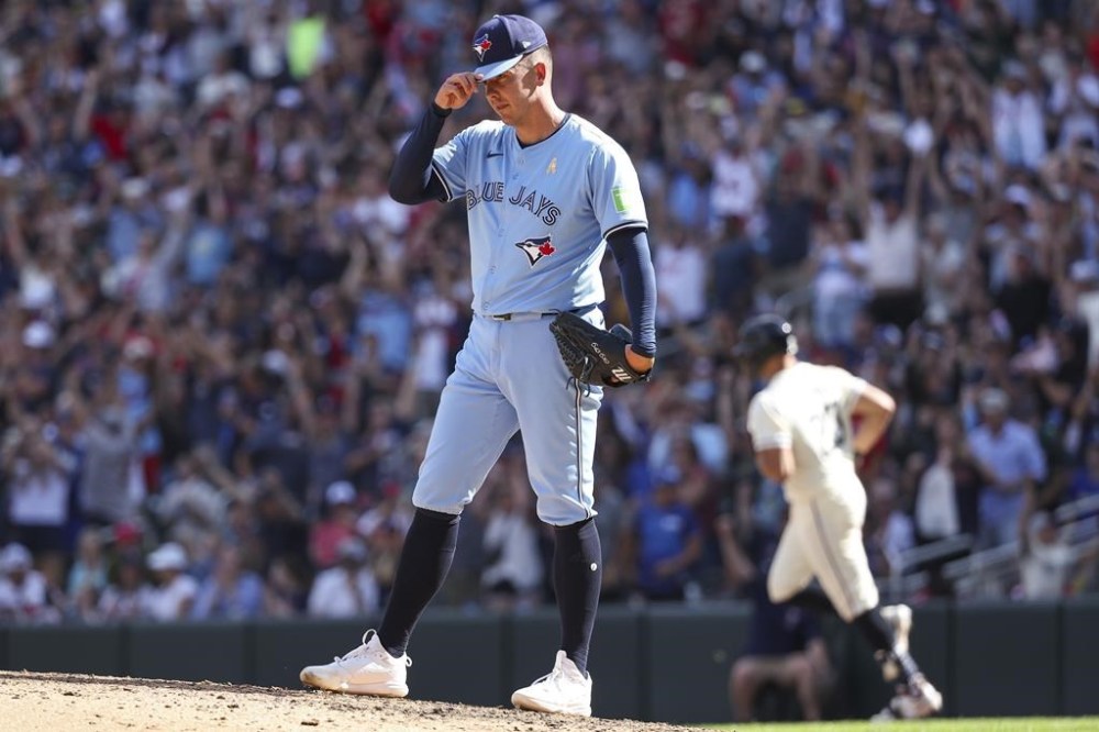 Toronto Blue Jays relief pitcher Chad Green reacts after giving up a three-run home run to Minnesota Twins' Royce Lewis during the eighth inning of a baseball game, Sunday, Sept. 1, 2024, in Minneapolis. (AP Photo/Matt Krohn)