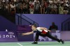 Oksana Kozyna, from Ukraine, lunges to hit the shuttlecock during the semifinal match of the Para Badminton SL3 classification against Qonitah Ikhtiar Syakuroh from Indonesia during the Paralympic Games in Paris on Sunday, Sept. 1, 2024. Syakuroh won the game in straight sets. (AP Photo/Avni Trivedi)