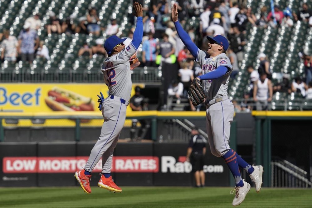 New York Mets' Francisco Lindor, left, celebrates with Brandon Nimmo, right, after they defeated the Chicago White Sox in a baseball game in Chicago, Sunday, Sept. 1, 2024. (AP Photo/Nam Y. Huh)