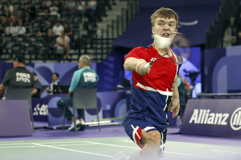 Miles Krajewski from the U.S. hits the shuttlecock during the gold medal mixed doubles SH6 match against Naili Lin and Fengmei Li, from China, during the Paralympic Games in Paris on Monday, Sept. 2, 2024. China won the match in straight sets. (AP Photo/Avni Trivedi)