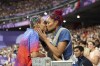 Roderick Townsend of the United States kisses his wife Tynita Townsend, with their son Rodney Townsend, between Rodrick's jumps in the T47 Men's High Jump at the 2024 Paralympics, Sunday, Sept. 1, 2024 in Paris, France. (AP Photo/Caleb Craig)