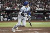 Los Angeles Dodgers' Shohei Ohtani hits a single against the Arizona Diamondbacks in the seventh inning during a baseball game, Monday, Sept. 2, 2024, in Phoenix. (AP Photo/Rick Scuteri)