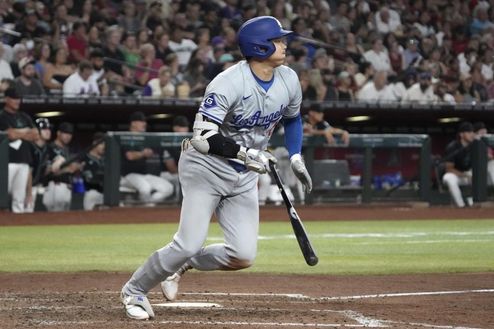 Los Angeles Dodgers' Shohei Ohtani hits a single against the Arizona Diamondbacks in the seventh inning during a baseball game, Monday, Sept. 2, 2024, in Phoenix. (AP Photo/Rick Scuteri)