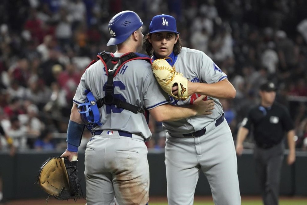 Los Angeles Dodgers catcher Will Smith, left, and pitcher Brent Honeywell, right, celebrate after defeating the Arizona Diamondbacks in a baseball game, Monday, Sept. 2, 2024, in Phoenix. (AP Photo/Rick Scuteri)
