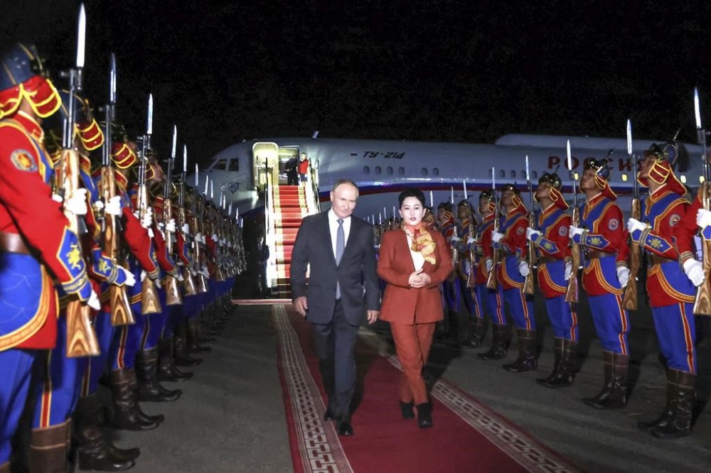 Russian President Vladimir Putin, on red carpet left, walks next to Mongolian Foreign Minister of Mongolia, Batmunkh Battsetseg upon his arrival at Ulaanbaatar's International airport Chinggis Khaan, late Monday, Sept. 2, 2024. (Natalia Gubernatorova, Sputnik, Kremlin Pool Photo via AP)