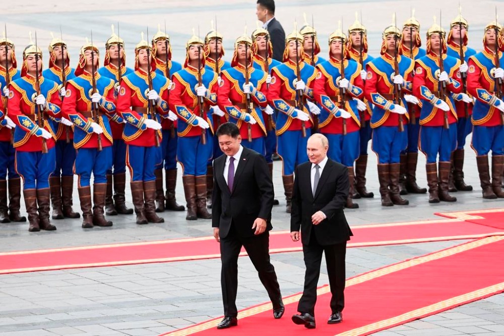 Russian President Vladimir Putin, right, walks with Mongolian President Ukhnaagiin Khurelsukh, left, during welcoming ceremony at Sukhbaatar Square in Ulaanbaatar, Mongolia, Tuesday, Sept. 3, 2024. (Sofya Sandurskaya, Sputnik, Kremlin Pool Photo via AP)