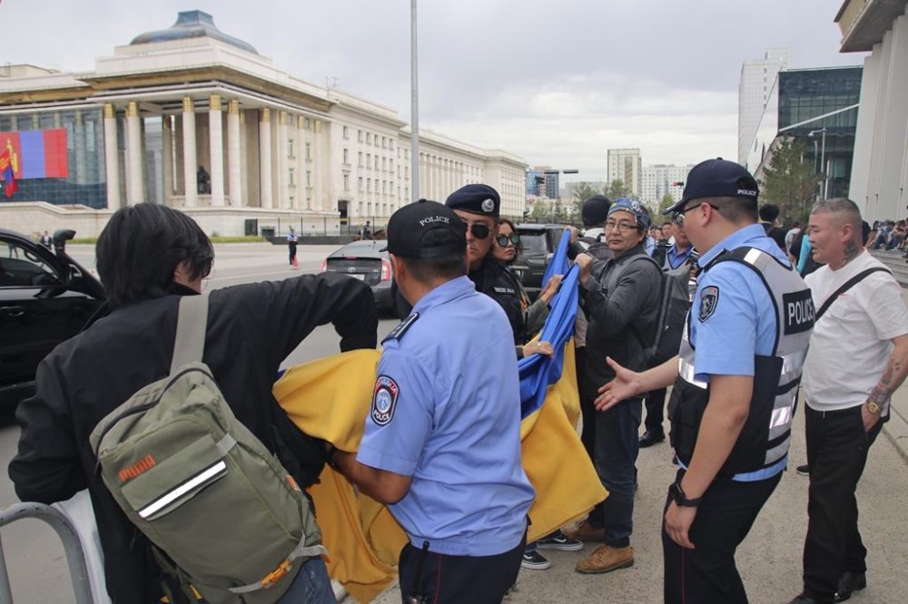 Police and security officers prevent members of the