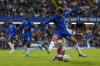 Chelsea's Pedro Neto, front, duels for the ball with Servette's Derek Kutesa during the Europa Conference League play-off first leg soccer match between Chelsea and Servette, at Stamford Bridge stadium in London, Thursday, Aug. 22, 2024. (AP Photo/Alastair Grant)