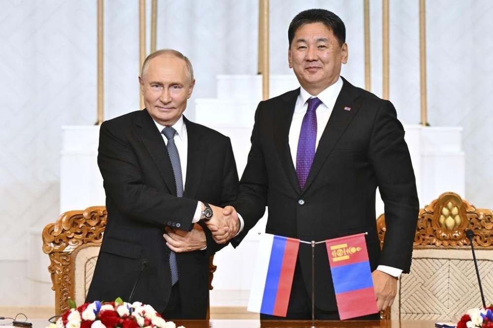 Russian President Vladimir Putin, left, and Mongolian President Ukhnaagiin Khurelsukh shake hands as they make a statement following the Russian-Mongolian talks at the Government Palace in Ulaanbaatar, Mongolia, Tuesday, Sept. 3, 2024. (Kristina Kormilitsyna, Sputnik, Kremlin Pool Photo via AP)