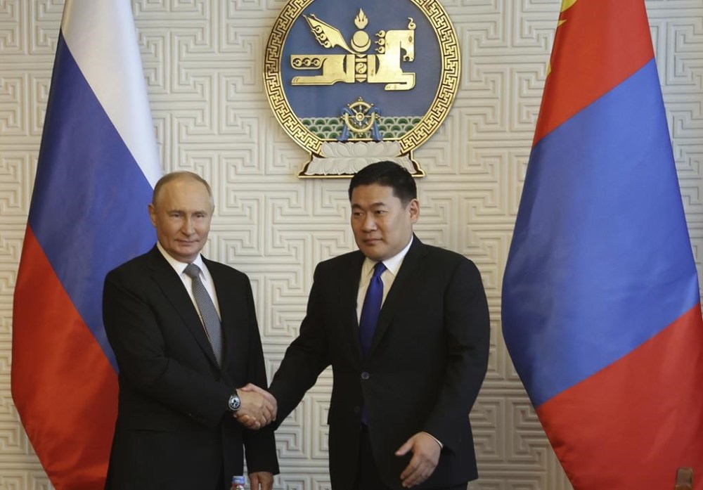 Russian President Vladimir Putin and Mongolian Prime Minister Luvsannamsrain Oyun-Erdene shake hands as they pose for photos during their meeting at the Government Palace in Ulaanbaatar, Mongolia, Tuesday, Sept. 3, 2024. (Vyacheslav Prokofyev, Sputnik, Kremlin Pool Photo via AP)