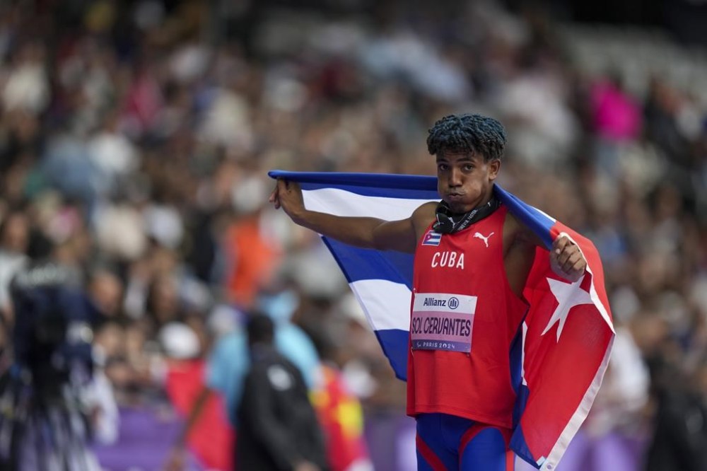 Cuba's Robiel Yankiel Sol Cervantes celebrates after winning the men's long jump T47 during the 2024 Paralympics, Tuesday, Sept. 3, 2024, in Paris, France. (AP Photo/Thibault Camus)