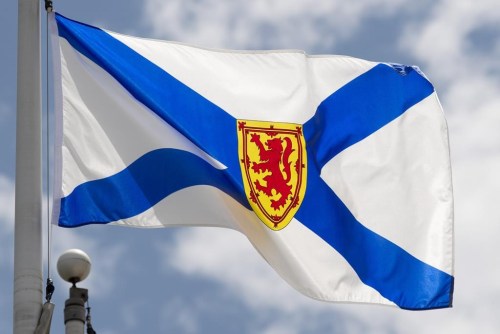 Nova Scotia's provincial flag flies on a flagpole in Ottawa, Friday, July 3, 2020. The Nova Scotia Nature Trust says it plans to complete its largest acquisition of privately owned coastline by the end of the month. THE CANADIAN PRESS/Adrian Wyld