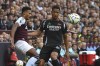 Aston Villa's Ollie Watkins, left, challenges for the ball with Arsenal's William Saliba during the English Premier League soccer match between Aston Villa and Arsenal at Villa Park in Birmingham, England, Saturday, Aug. 24, 2024. (AP Photo/Rui Vieira)