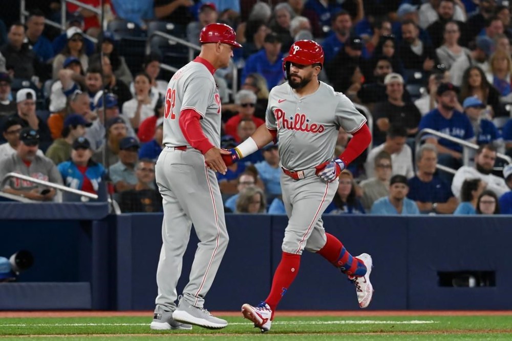 Philadelphia Phillies' Kyle Schwarber, right, celebrates hitting a solo home run in the fourth inning of a baseball game against the Toronto Blue Jays in Toronto on Tuesday Sept. 3, 2024. THE CANADIAN PRESS/Jon Blacker