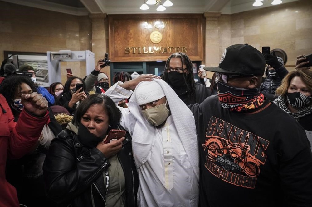 FILE - Myon Burrell is surrounded by family upon his release from prison at the Minnesota Correctional Facility-Stillwater in Bayport, Minn., Dec. 15, 2020. (AP Photo/John Minchillo, File)