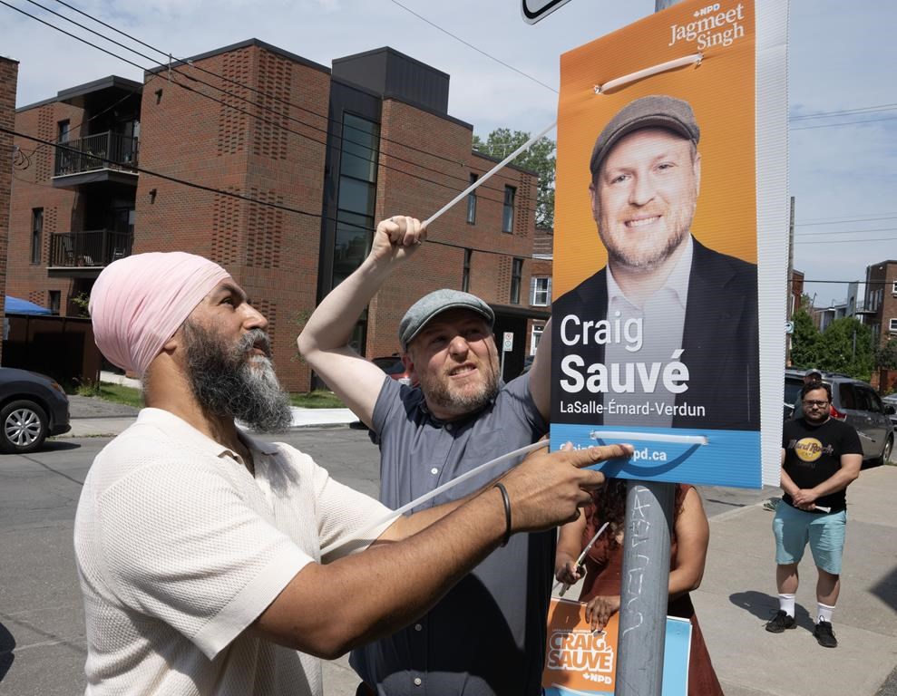 NDP Leader Jagmeet Singh puts up campaign posters with candidate Craig Sauve Monday, July 29, 2024, in Montreal. A federal byelection will be held in the riding of LaSalle—Émard—Verdun on Sept. 16, 2024.THE CANADIAN PRESS/Ryan Remiorz