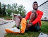 Para long jumper Noah Vucsis puts on his spikes before a training session in Calgary, Tuesday, May 28, 2024.THE CANADIAN PRESS/Jeff McIntosh