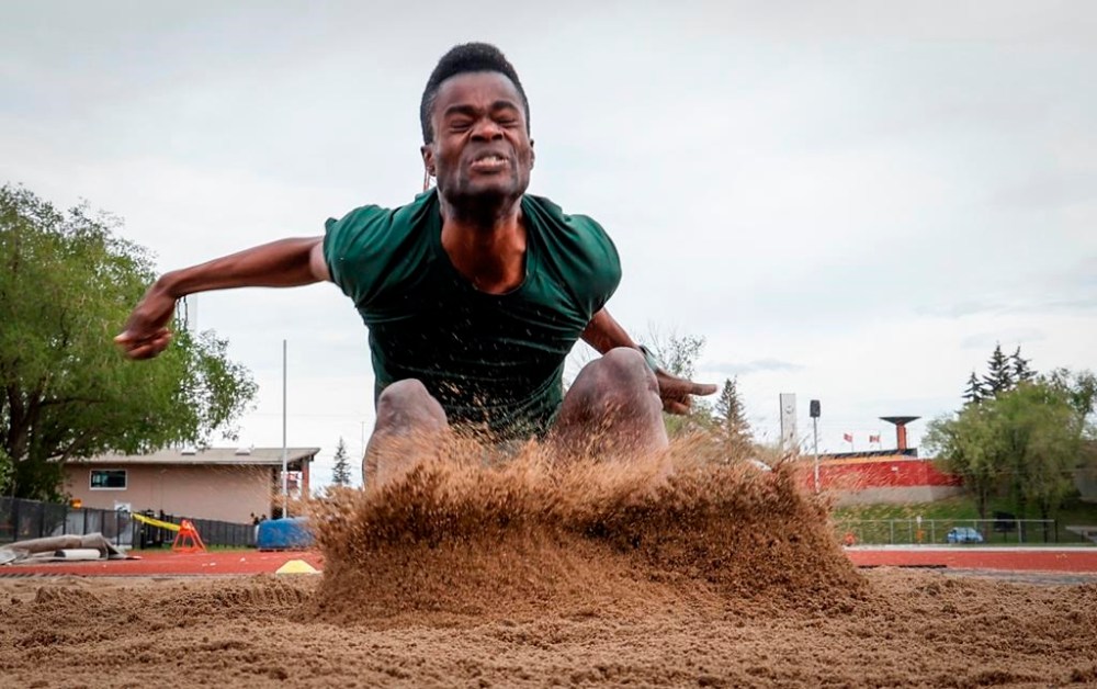 Para long jumper Noah Vucsis lands in a sand pit during a training session in Calgary, Tuesday, May 28, 2024.THE CANADIAN PRESS/Jeff McIntosh