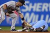 Philadelphia Phillies' Bryson Stott, right, steals second past Atlanta Braves second baseman Whit Merrifield during the fourth inning of a baseball game, Thursday, Aug. 29, 2024, in Philadelphia. (AP Photo/Matt Slocum)