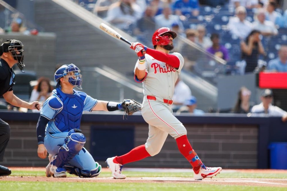 Philadelphia Phillies designated hitter Kyle Schwarber (12) hits a solo-home run in the first inning interleague MLB baseball action against the Toronto Blue Jays in Toronto on Wednesday, September 4, 2024. THE CANADIAN PRESS/Cole Burston