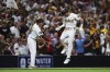 San Diego Padres' Jackson Merrill, right, celebrates with third base coach Tim Leiper as he runs the bases after hitting a three-run home run against the Detroit Tigers in the fourth inning of a baseball game Wednesday, Sept. 4, 2024, in San Diego. (AP Photo/Derrick Tuskan)