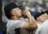 New York Yankees' Giancarlo Stanton watches from the dugout during the ninth inning of a baseball game against the Texas Rangers Wednesday, Sept. 4, 2024, in Arlington, Texas. (AP Photo/Jeffrey McWhorter)