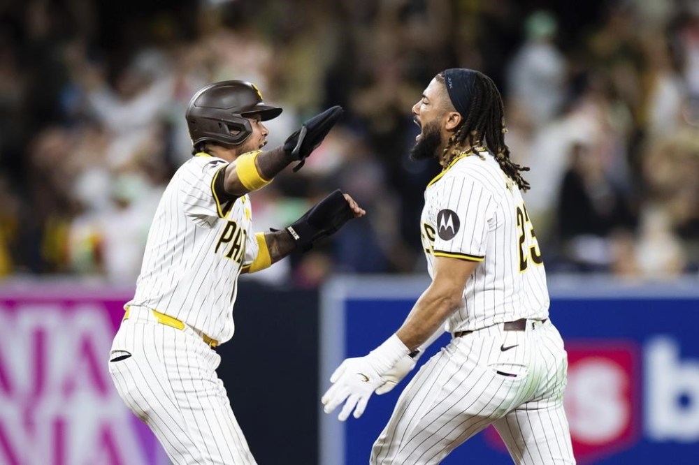 San Diego Padres' Fernando Tatis Jr., right, celebrates with Luis Arraez after hitting a walk-off single against the Detroit Tigers in the tenth inning of a baseball game Wednesday, Sept. 4, 2024, in San Diego. (AP Photo/Derrick Tuskan)