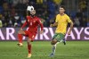 Bahrain's Mohamed Marhoon, left, competes with Australia's Alessandro Circati for the ball during their World Cup 2026 qualifying match at the Gold Coast, Australia, Thursday, Sept. 5, 2024. (Dave Hunt/AAP Image via AP)