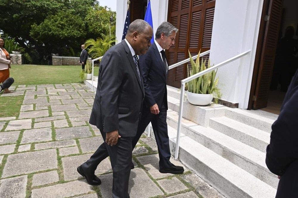 Haitian Prime Minister Garry Conille, front, and U.S. Secretary of State Antony Blinken enter the U.S. Chief of Mission Residence after speaking to the press in Port-au-Prince, Haiti, Thursday, Sept. 5, 2024. (Roberto Schmidt/Pool photo via AP)