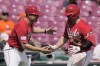 Cincinnati Reds' Ty France, right, celebrates with third base coach J.R. House as he rounds the bases after hitting a home run during the seventh inning of a baseball game against the Houston Astros, Thursday, Sept. 5, 2024, in Cincinnati. (AP Photo/Carolyn Kaster)