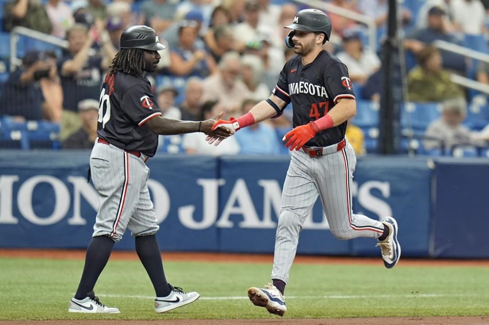 Minnesota Twins' Edouard Julien (47) celebrates his three-run home run off Tampa Bay Rays starting pitcher Taj Bradley with third base coach Tommy Watkins during the second inning of a baseball game Thursday, Sept. 5, 2024, in St. Petersburg, Fla. (AP Photo/Chris O'Meara)