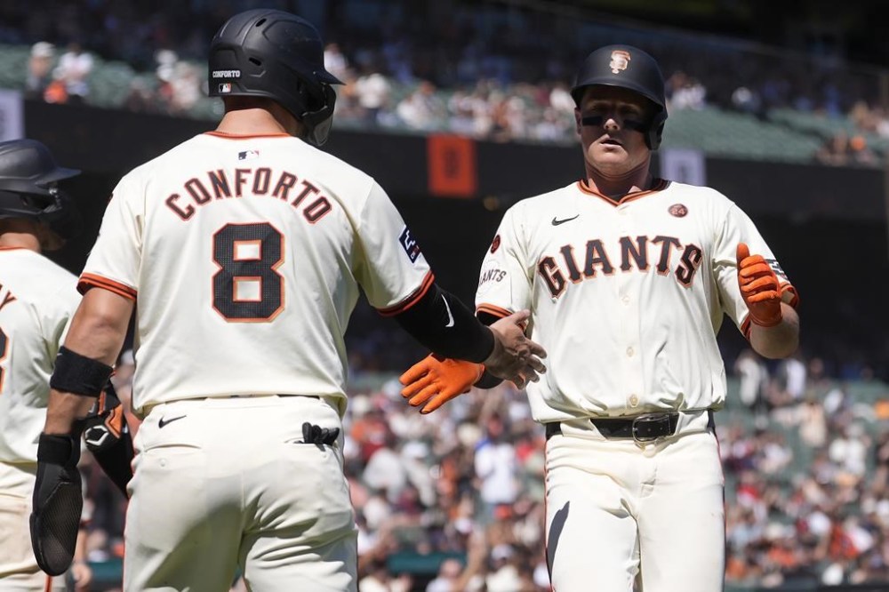 San Francisco Giants' Michael Conforto (8) celebrates with Matt Chapman after both scored on a two-run single by Patrick Bailey during the fourth inning of a baseball game against the Arizona Diamondbacks in San Francisco, Thursday, Sept. 5, 2024. (AP Photo/Jeff Chiu)