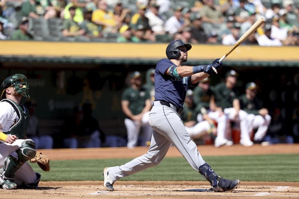 Seattle Mariners catcher Cal Raleigh, right, watches his two-run home run in front of Oakland Athletics catcher Kyle McCann, left, during the first inning of a baseball game in Oakland, Calif., Thursday, Sept. 5, 2024. (AP Photo/Jed Jacobsohn)