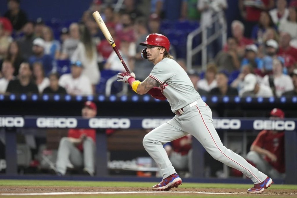 Philadelphia Phillies' Bryson Stott follows through on an RBI single to score Trea Turner during the first inning of a baseball game against the Miami Marlins, Thursday, Sept. 5, 2024, in Miami. (AP Photo/Lynne Sladky)