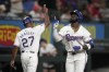 Texas Rangers' Adolis Garcia, right, and third base coach Tony Beasley (27) celebrate Garcia's three-run home run against the Los Angeles Angels in the first inning of a baseball game Thursday, Sept. 5, 2024, in Arlington, Texas. (AP Photo/Tony Gutierrez)