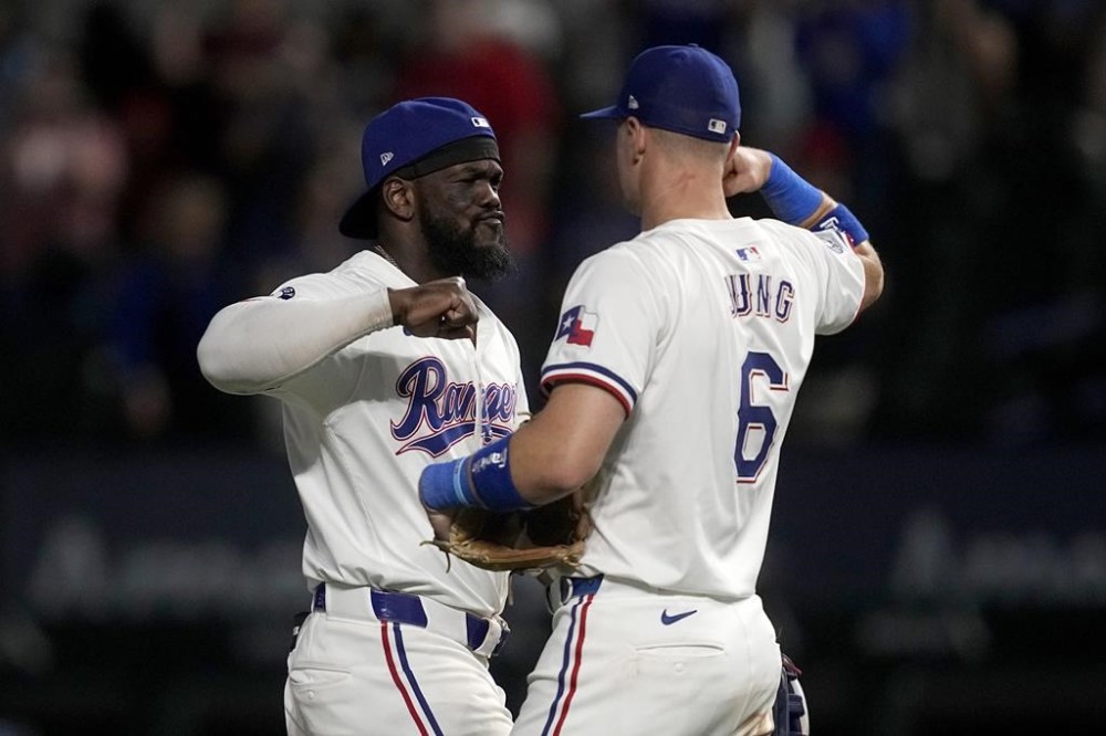 Texas Rangers' Adolis Garcia, left, and Josh Jung (6) celebrate after their win over the Los Angeles Angels in a baseball game Thursday, Sept. 5, 2024, in Arlington, Texas. (AP Photo/Tony Gutierrez)