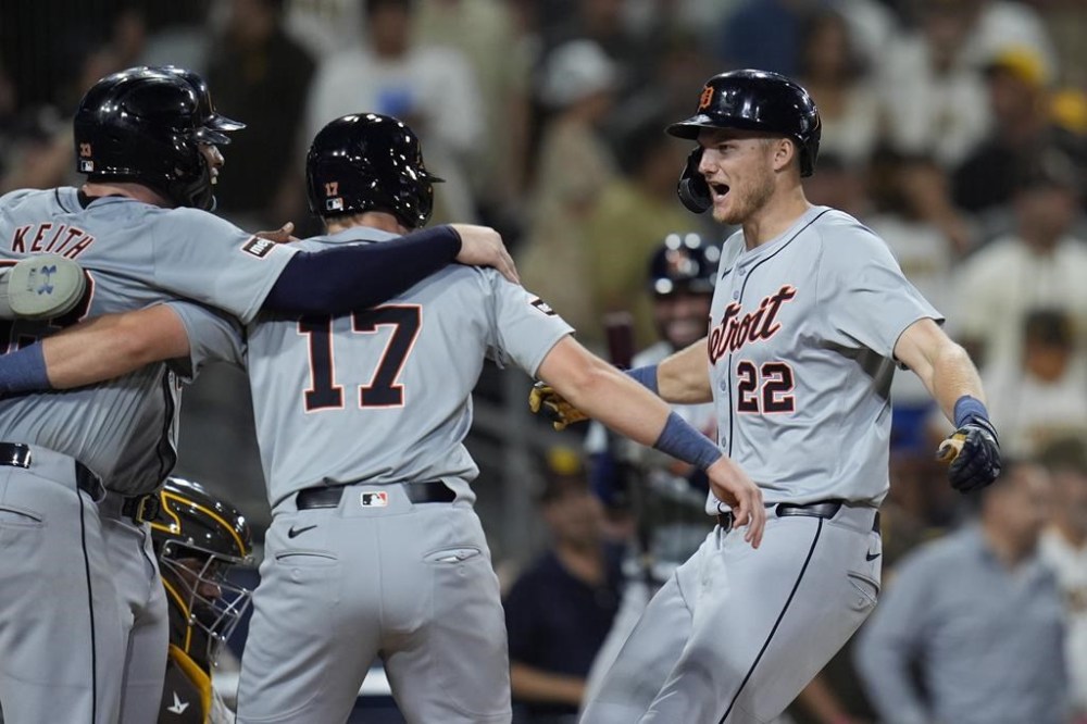 Detroit Tigers' Parker Meadows, right, celebrates with teammates Jace Jung, center, and Colt Keith, left, after hitting a grand slam during the ninth inning of a baseball game against the San Diego Padres, Thursday, Sept. 5, 2024, in San Diego. (AP Photo/Gregory Bull)