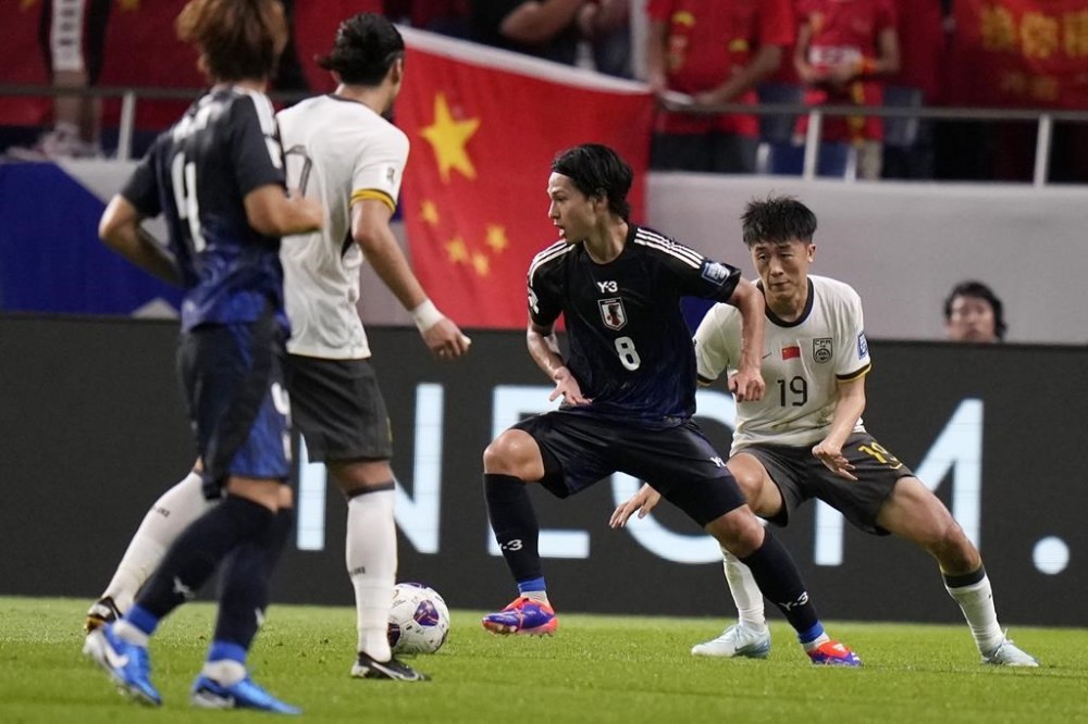 Japan's Takumi Minamino and China's Liu Yangyi compete for the ball during a World Cup and AFC Asian Qualifier between Japan and China at Saitama Stadium 2002 in Saitama, north of Tokyo, Thursday, Sept. 5, 2024.(AP Photo/Shuji Kajiyama)