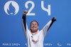 Britain's Sarah Storey celebrates on the podium after winning the women's C4-5 road race during the 2024 Paralympics, Friday, Sept. 6, 2024, in Clichy-sous-Bois, France. (AP Photo/Aurelien Morissard)