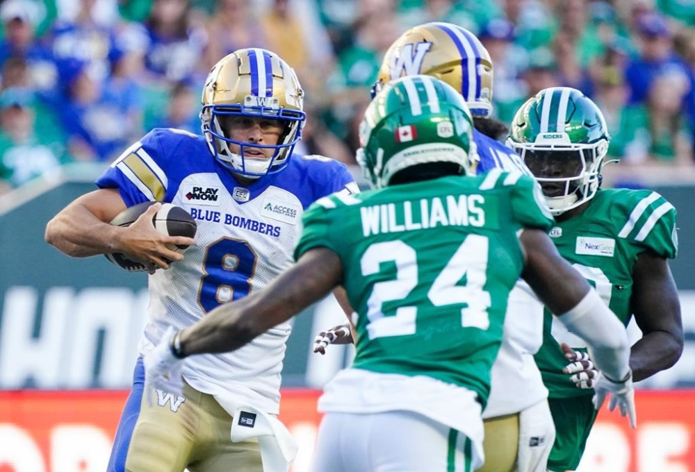 Winnipeg Blue Bombers quarterback Zach Collaros (8) runs the football against Saskatchewan Roughriders during the first half of CFL football action in Regina, on Sunday, September 1, 2024. There is some extra fire for when the Winnipeg Blue Bombers host the Saskatchewan Roughriders in the annual Banjo Bowl at Princess Auto Stadium on Saturday. THE CANADIAN PRESS/Heywood Yu