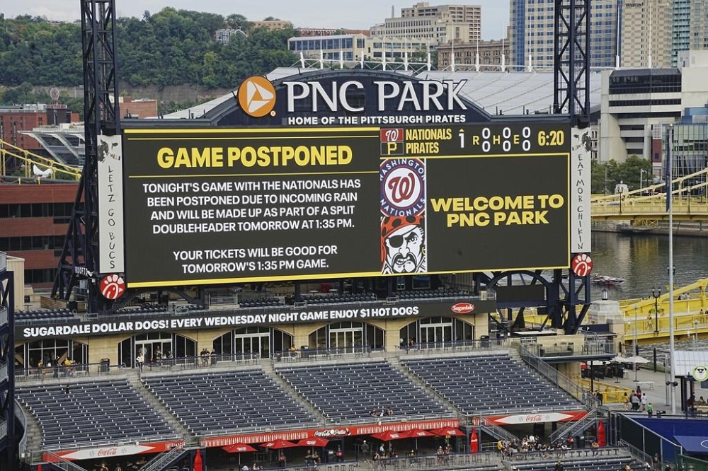 The scoreboard at PNC Park announces the postponement of a baseball game between the Pittsburgh Pirates and the Washington Nationals in Pittsburgh, Friday, Sept. 6, 2024. It will be played as part of a split doubleheader beginning a 1:35p Saturday, Sept 7, 2024. (AP Photo/Gene J. Puskar)