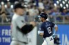 Kansas City Royals' Michael Massey (19) runs the bases past Minnesota Twins starting pitcher Zebby Matthews after hitting a solo home run during the fourth inning of a baseball game Friday, Sept. 6, 2024, in Kansas City, Mo. (AP Photo/Charlie Riedel)
