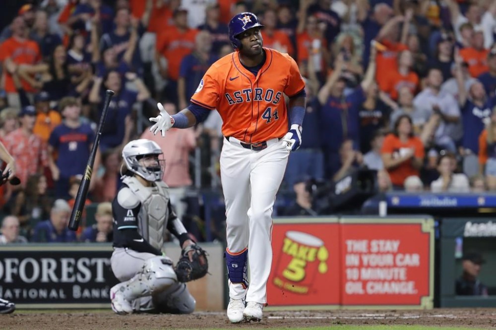 Houston Astros' Yordan Alvarez (44) flips his bat as he watches his three-run home run in front of Arizona Diamondbacks catcher Jose Herrera, left, during the fifth inning of a baseball game Friday, Sept. 6, 2024, in Houston. (AP Photo/Michael Wyke)