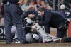Arizona Diamondbacks catcher Jose Herrera, center, is tended to by trainers after being hit in the head on the back swing by Houston Astros' Kyle Tucker during the fifth inning of a baseball game, Friday, Sept. 6, 2024, in Houston. Herrera left the game after the incident. (AP Photo/Michael Wyke)