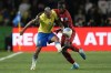 Ecuador's Moises Caicedo, right, and Brazil's Guilherme Arana battle for the ball during a qualifying soccer match for the FIFA World Cup 2026 at Couto Pereira Stadium in Curitiba, Parana state, Brazil, Friday, Sept. 6, 2024. (AP Photo/Silvia Izquierdo)